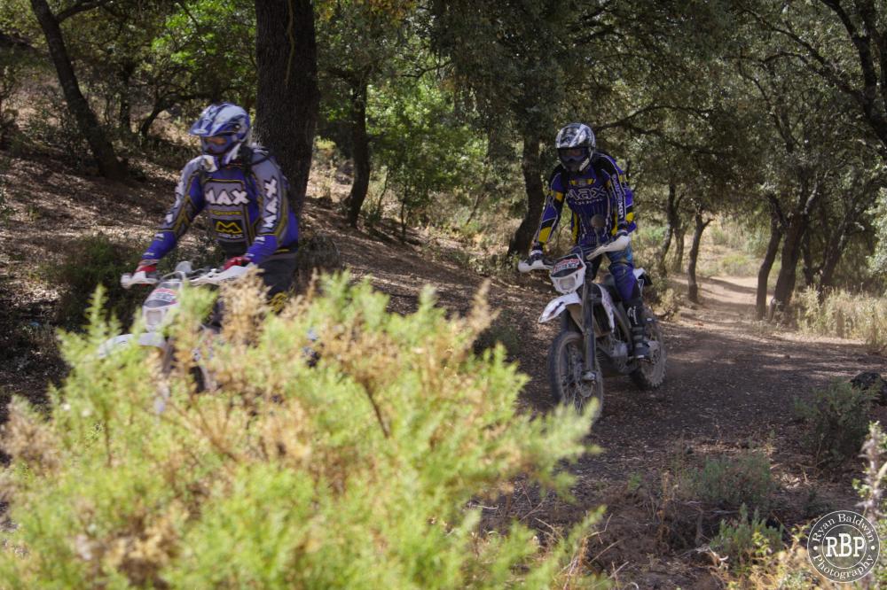 Two riders riding through the challenging spanish bushland